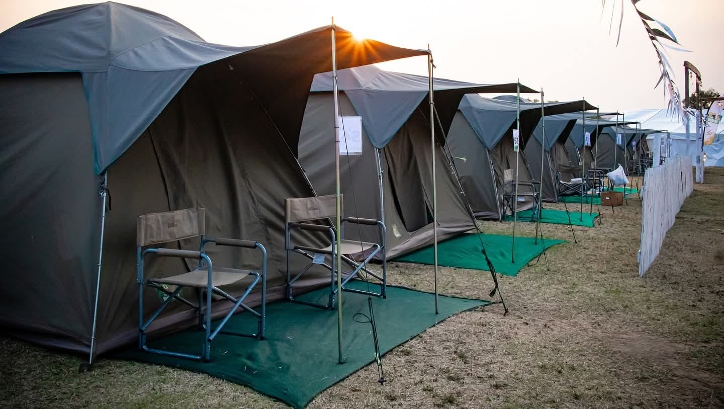 Canvas tents and covered seating at a campsite
