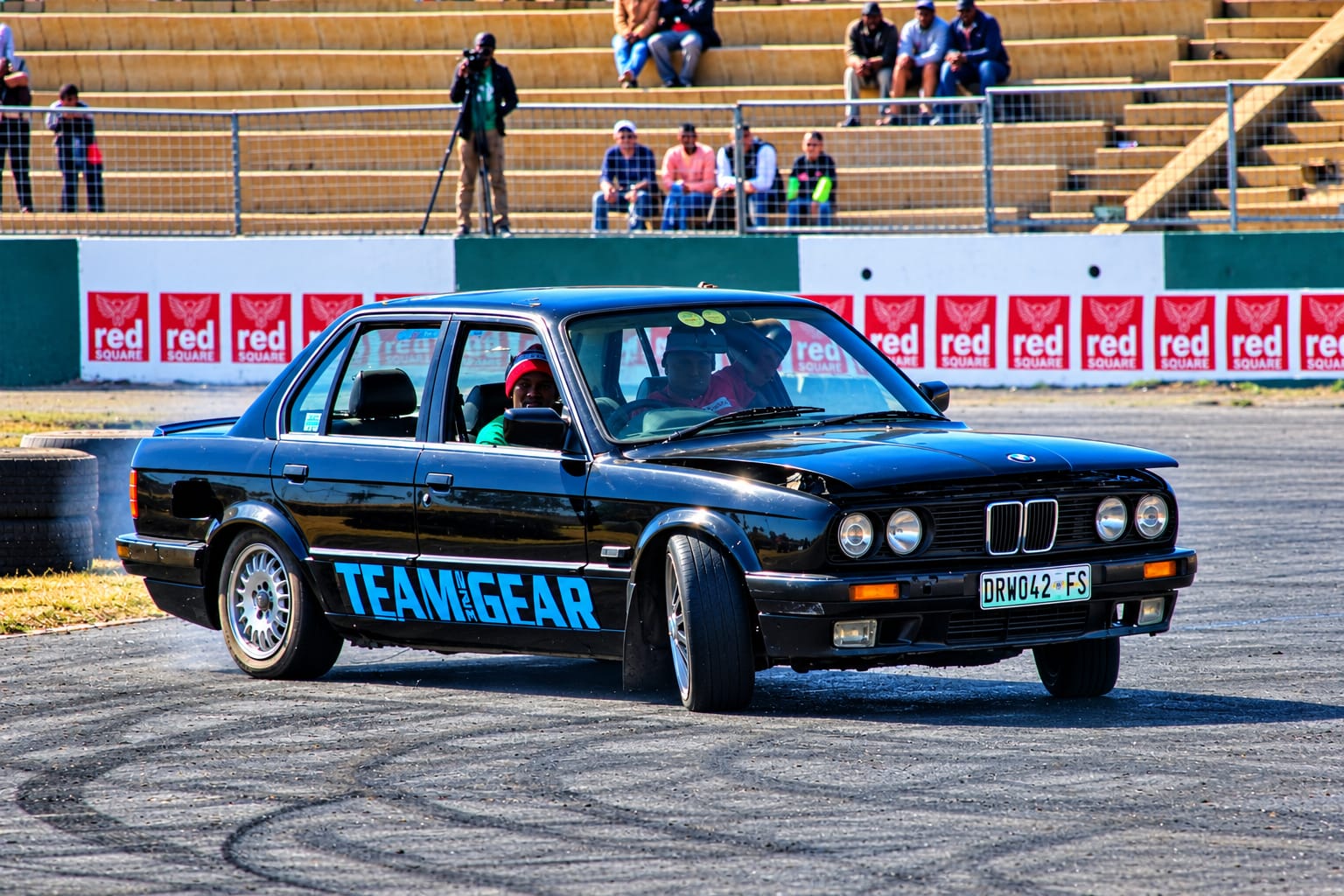 Black Team Gear BMW at an outdoor spinning arena